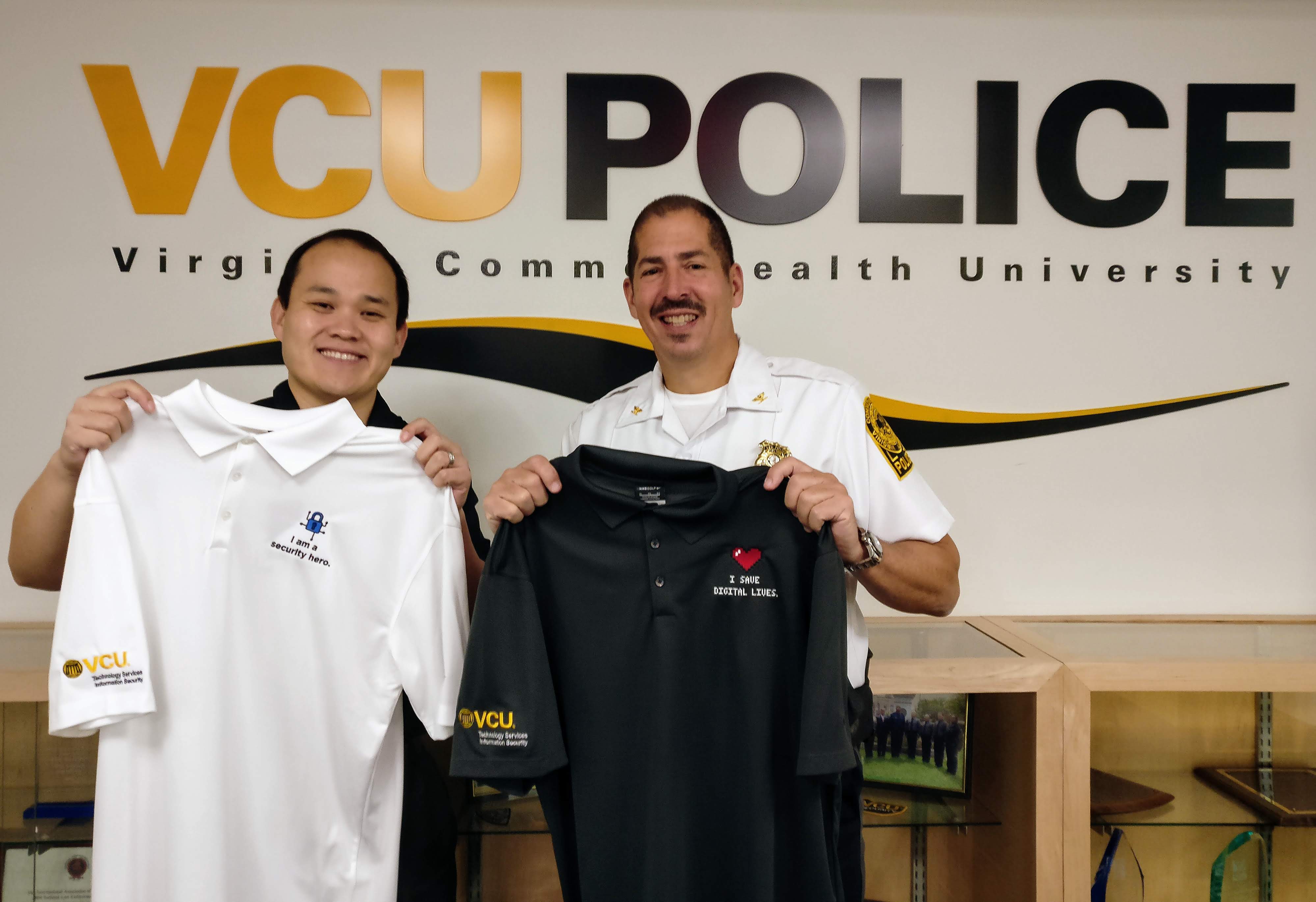 Photo of Dan Hand and Chief Venuti holding 2 polos from the security hero campaign